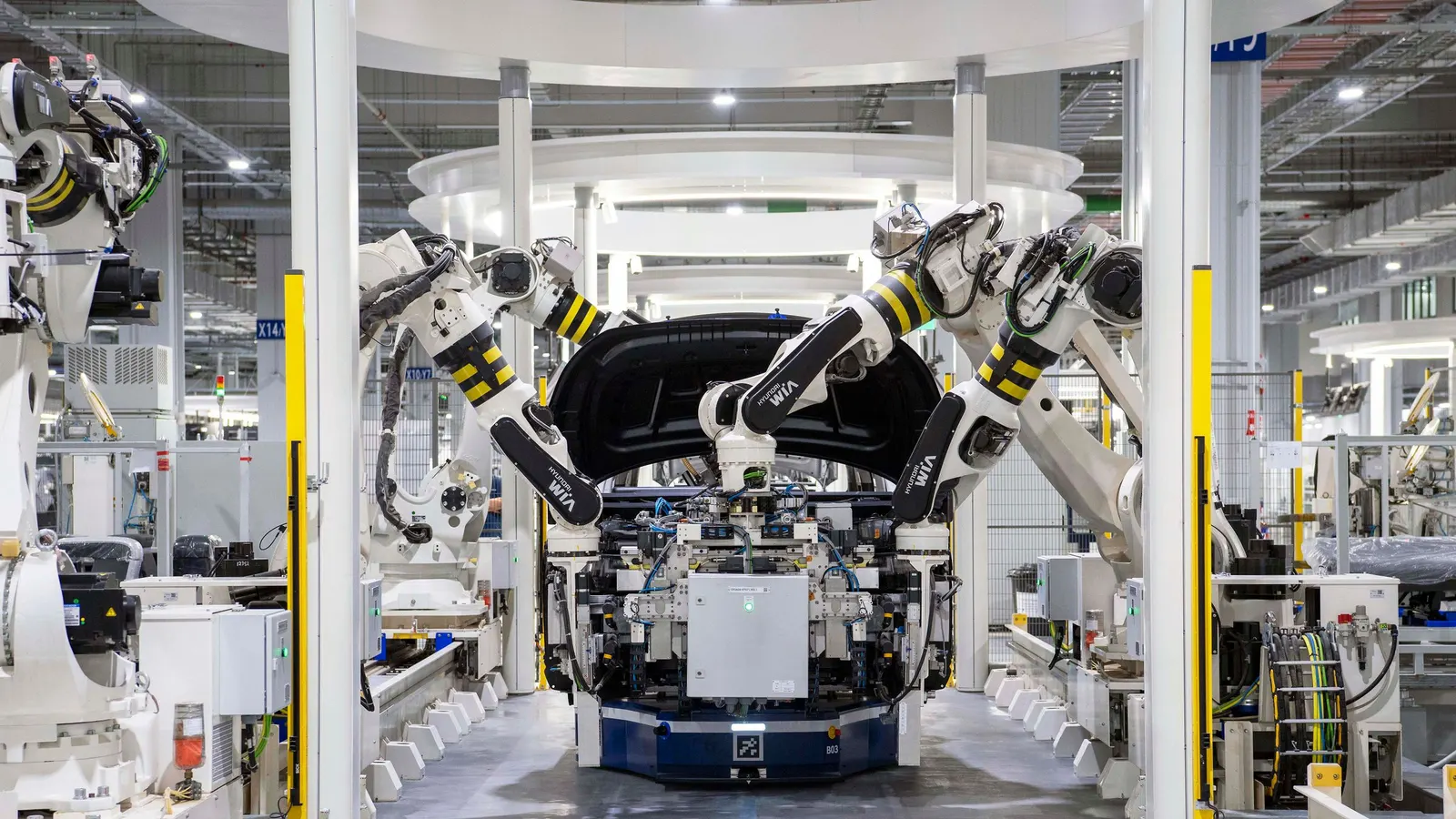 Robots assembling a car body on a factory line
